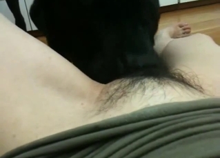 A black animal eats her wide-opened wet cunt